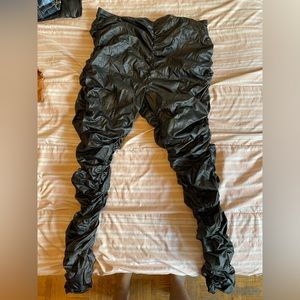 Black leather stacked pants